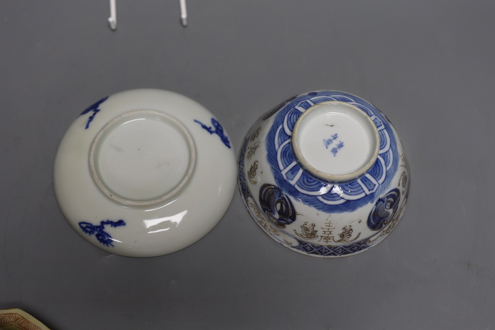 A Korean celadon bowl, a Chinese blue and white bowl, an iron red dish a famille Verte saucer and a Japanese blue and white saucer